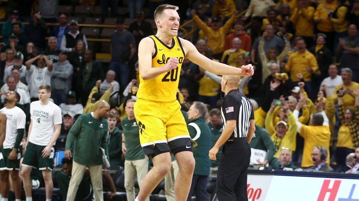 Payton Sandfort celebrates after hitting a three pointer