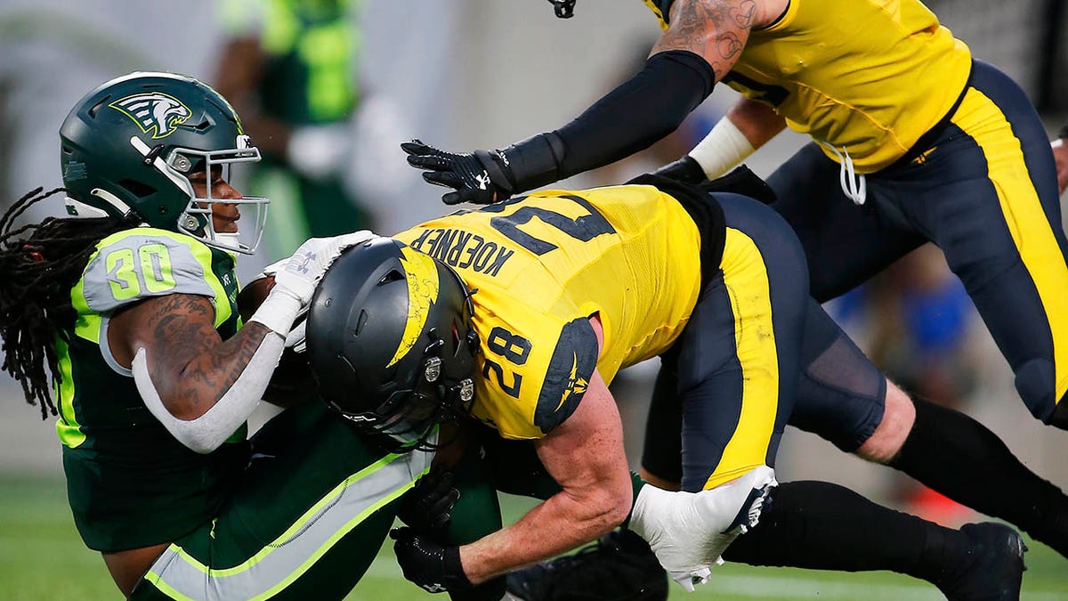 Jah-Maine Martin is tackled for a loss of yards during an XFL game