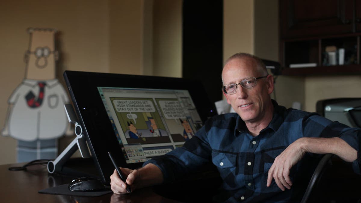 Dilbert creator Scott Adams at desk