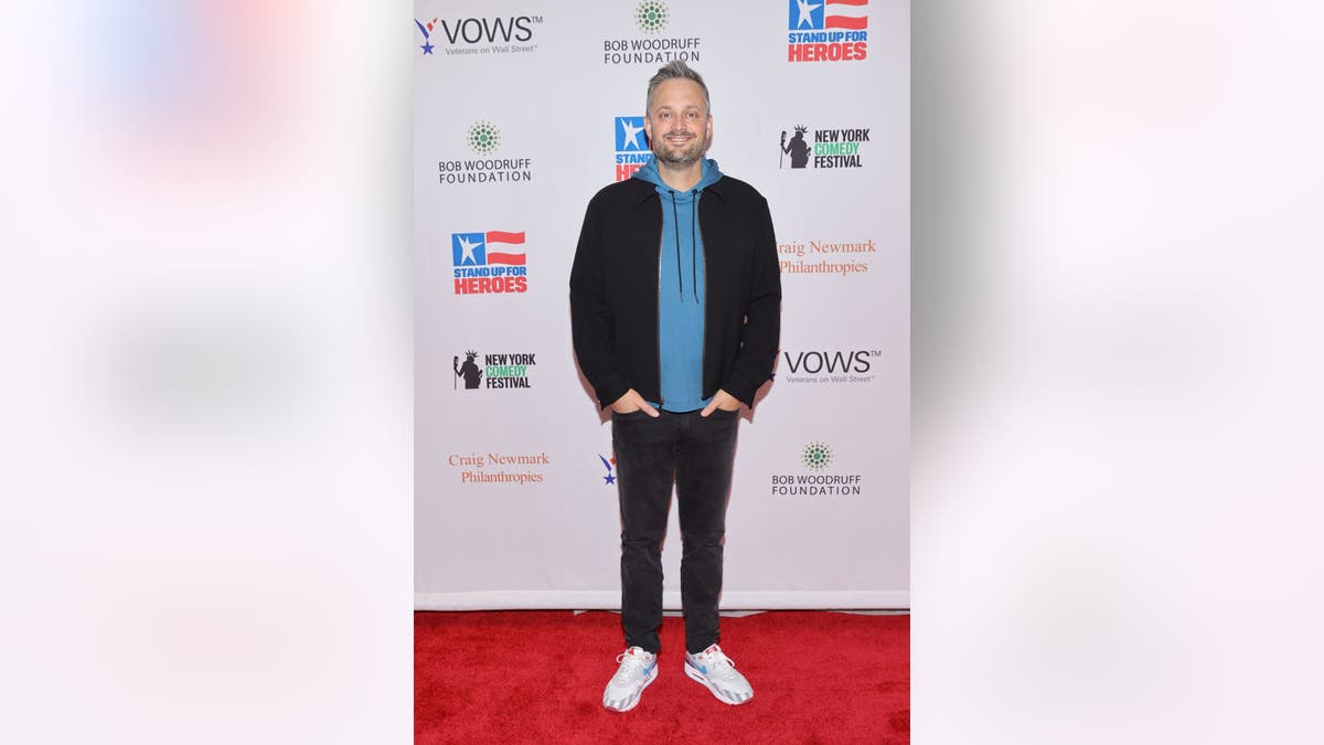 nate bargatze posing on a red carpet