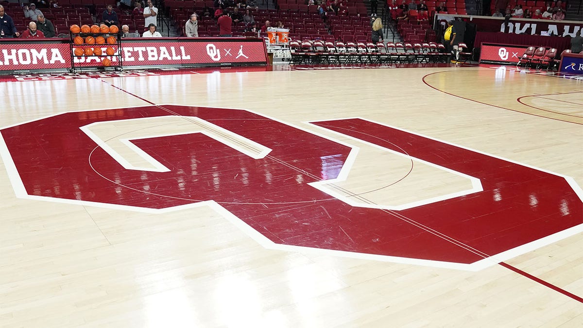 The Oklahoma Sooners logo on a basketball court