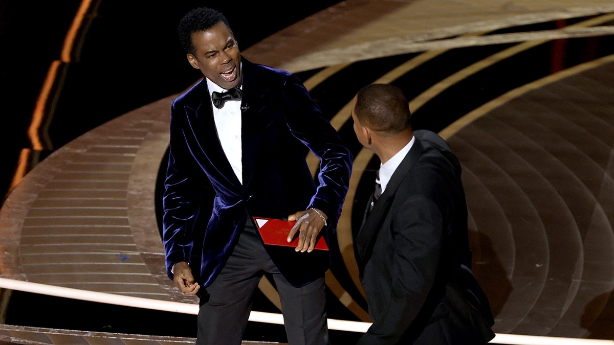 Chris Rock appears shocked after Will Smith slaps him across the face on the Oscars stage