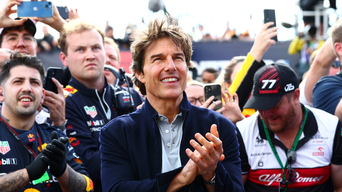 Tom Cruise clapping at racing event