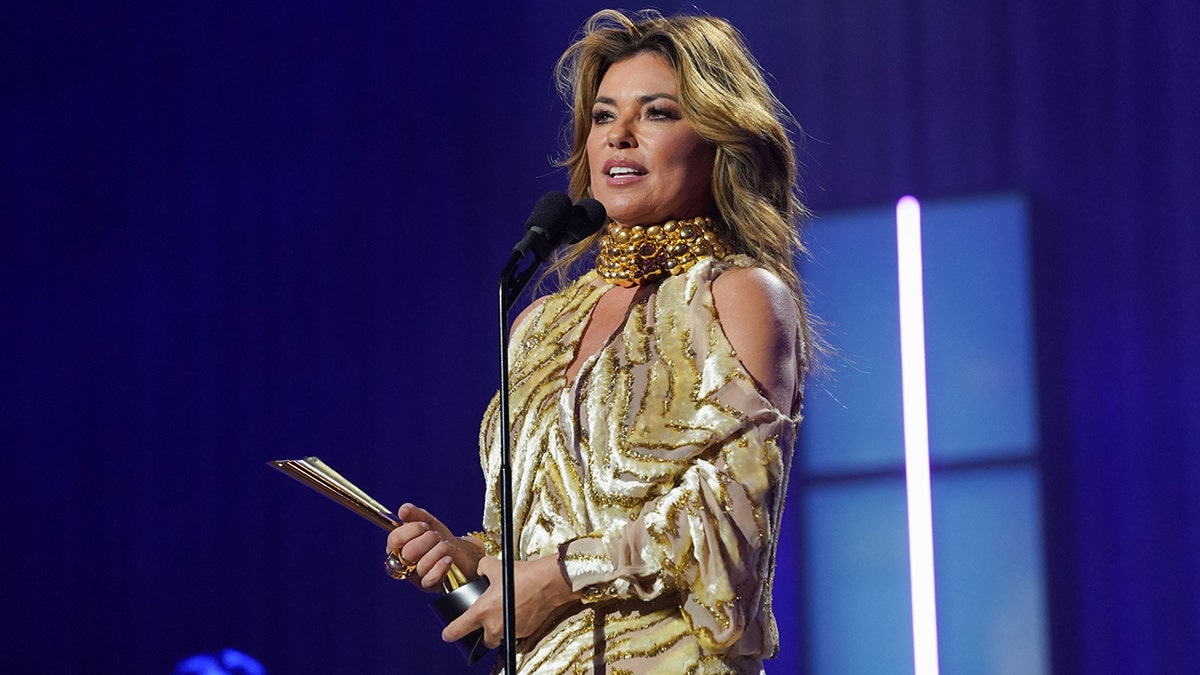 Shania Twain on stage at a microphone