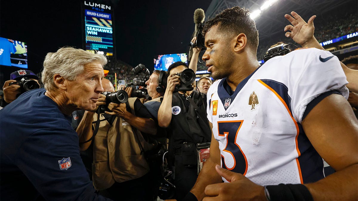 Pete Carroll and Russell Wilson shake hands
