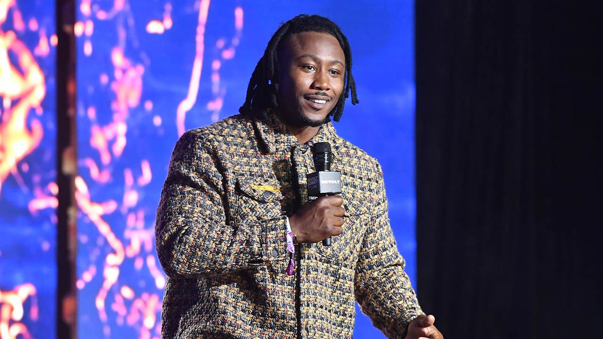 Brandon Marshall speaks at an events in 2022