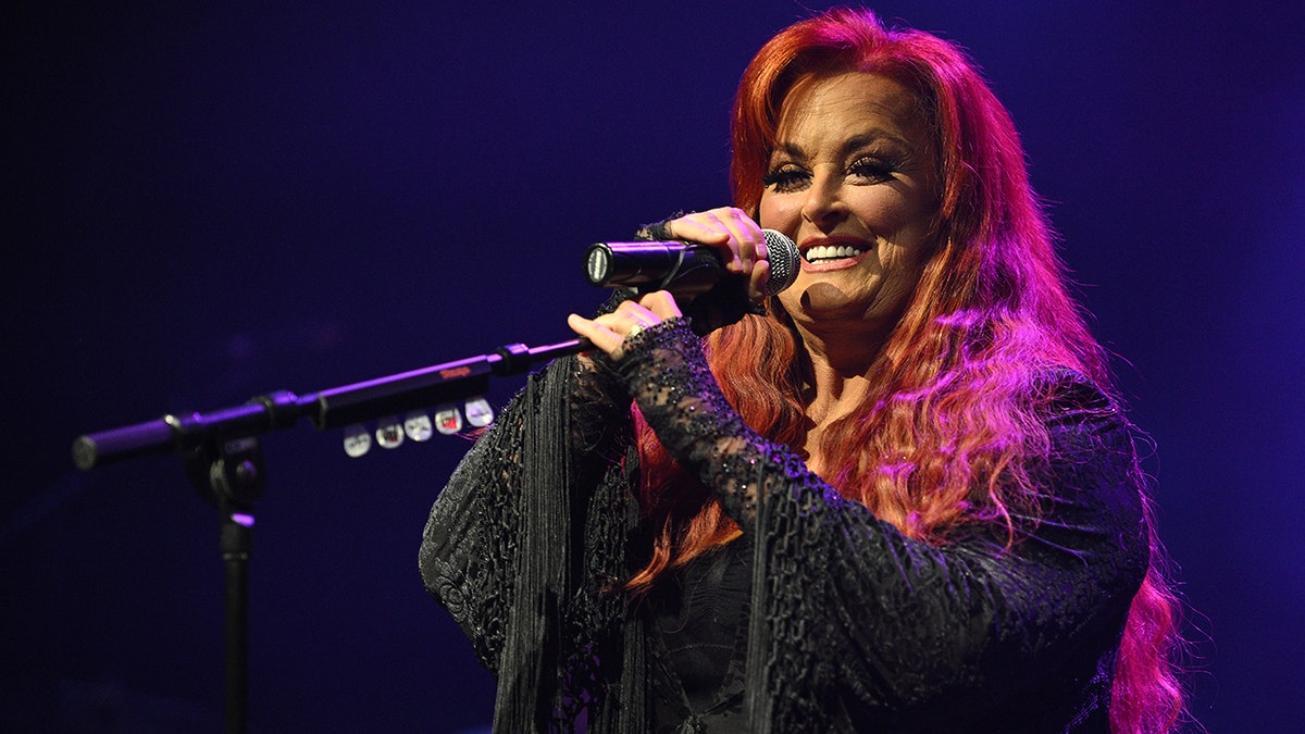 Wynonna Judd sings on stage.