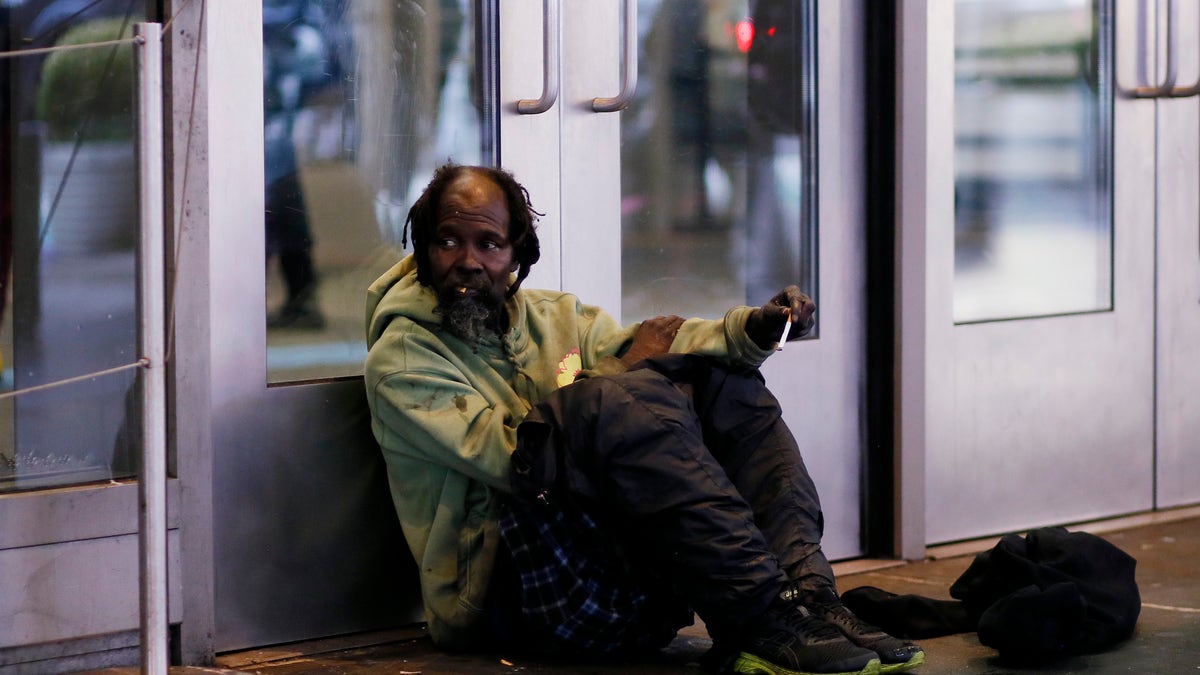 A homeless man sits at Times Square on November 30, 2022 in New York City. New York City, like many other major U.S. cities, continues to feel the wrath of the homeless crisis.