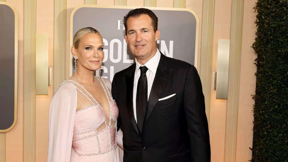 Molly Sims wears pink gown alongside husband Scott Stuber on Golden Globes red carpet