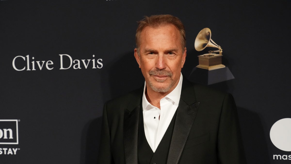 Kevin Costner wearing a black suit at an event