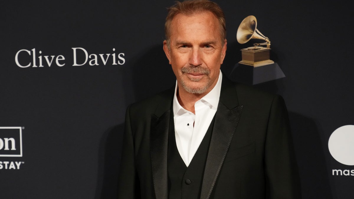 Kevin Costner wearing a black suit at an event