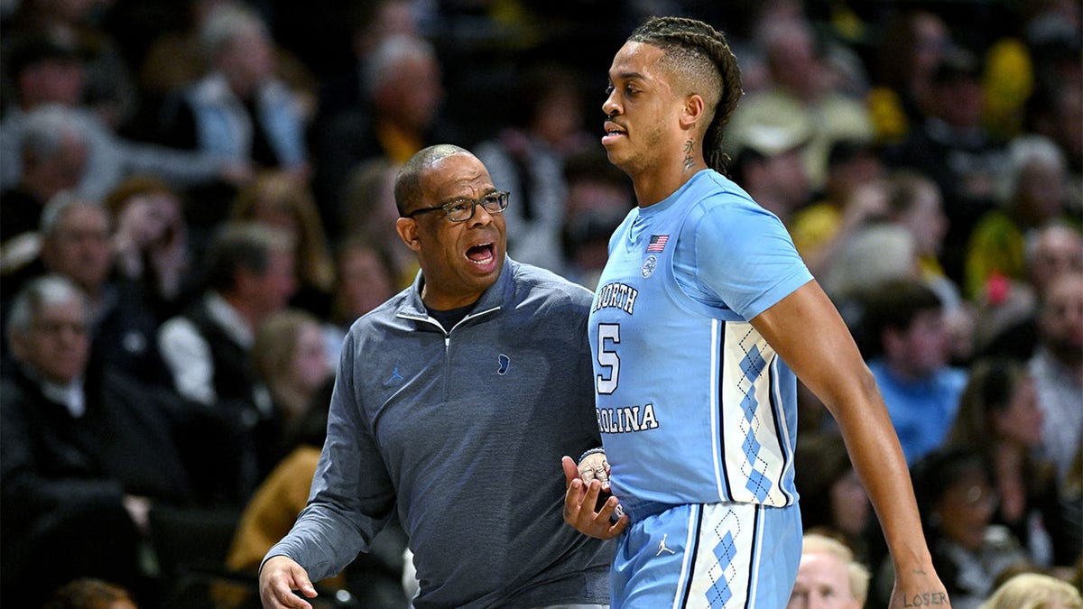 Hubert Davis talks with Armando Bacot against Wake Forest