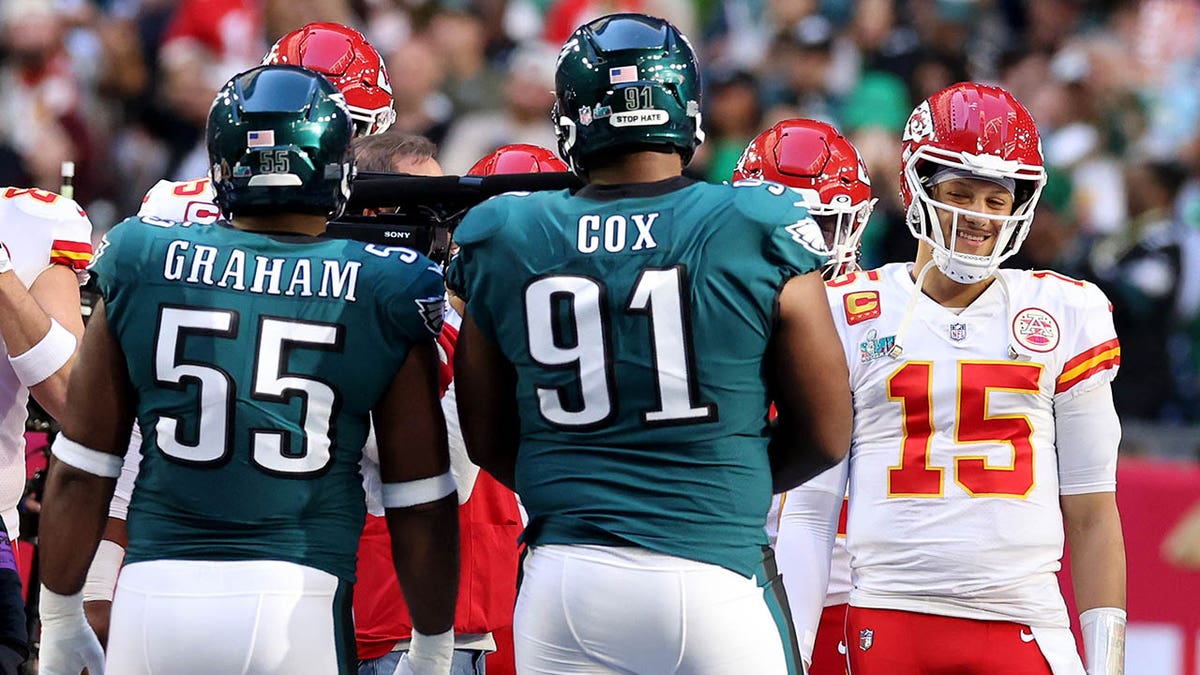 Chiefs and Eagles players meet at the coin toss in Super Bowl 57