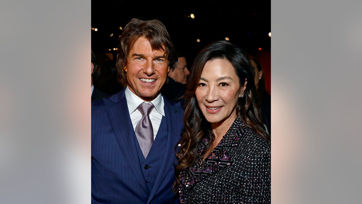 Tom Cruise poses next to Michelle Yeoh