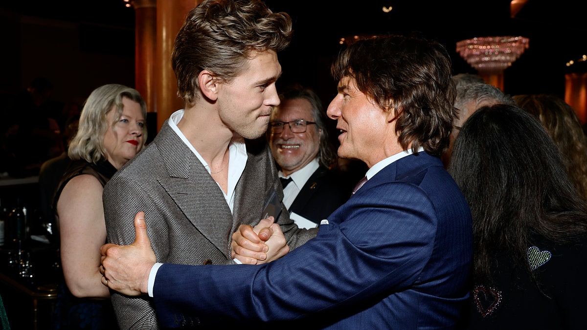 Austin Butler and tom Cruise embrace