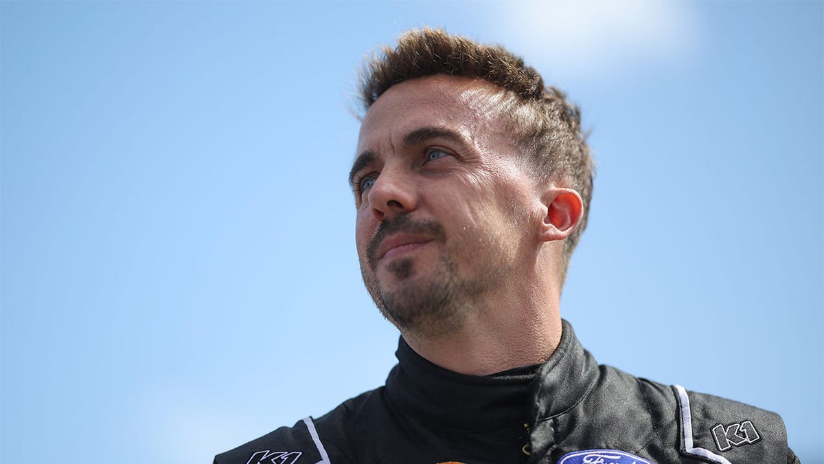 Frankie Muniz walks the grid before a race at Daytona