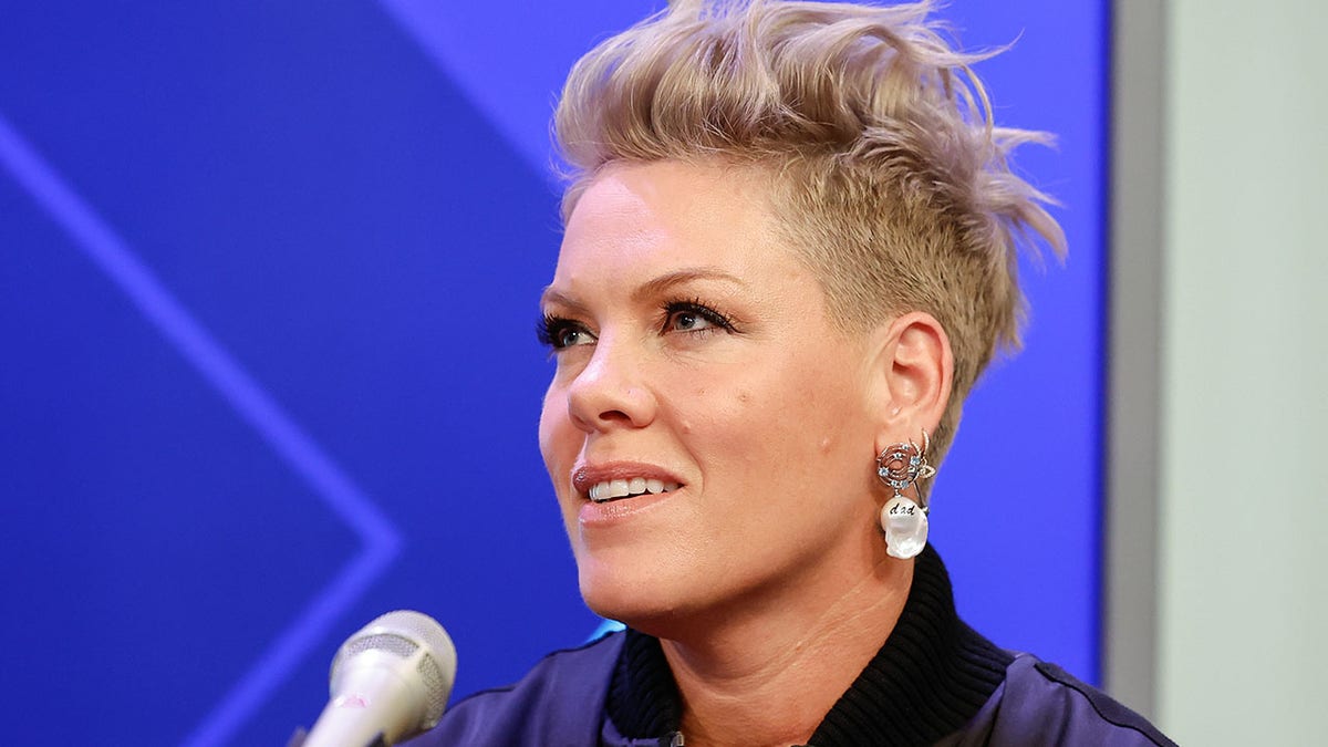 Pink looks up and off camera while giving an interview to SiriusXM and talking into a microphone