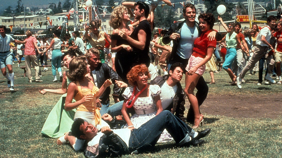 The cast of Grease in the carnival scene