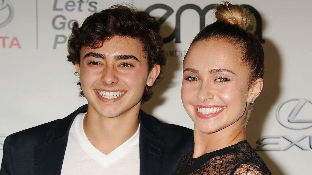  Hayden Panettiere beams on the red carpet wearing a black lace outfit next to younger brother Jansen in a white v-neck shirt and black suit