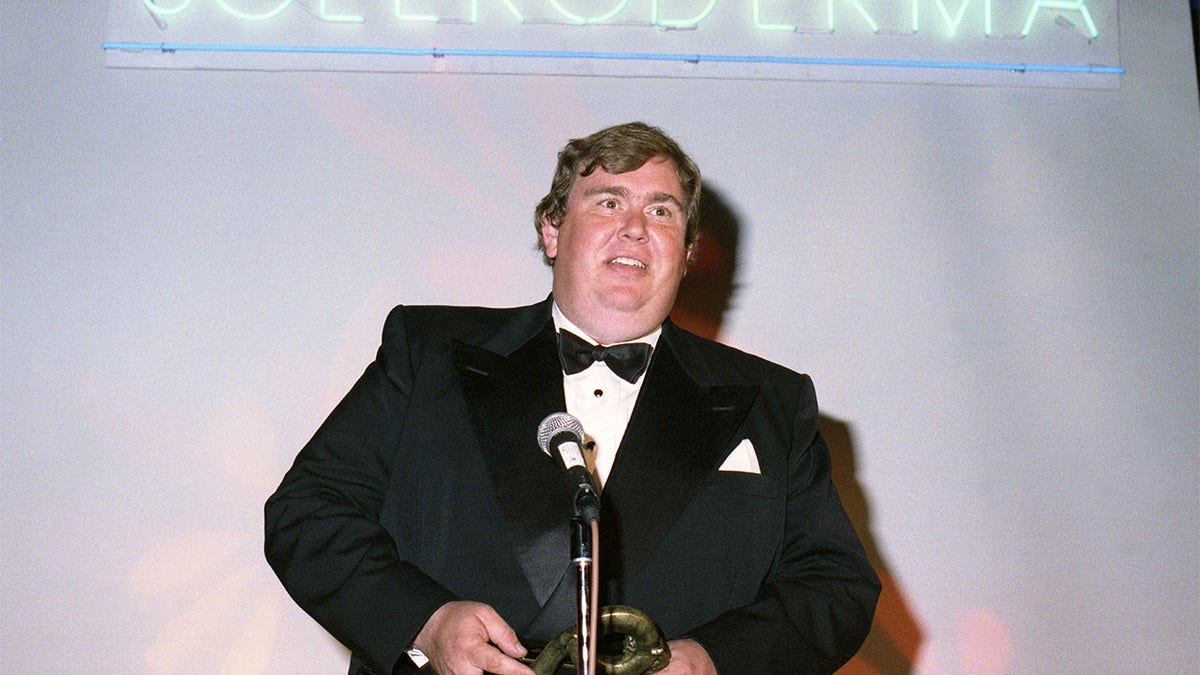 Actor John Candy receives an award in 1991