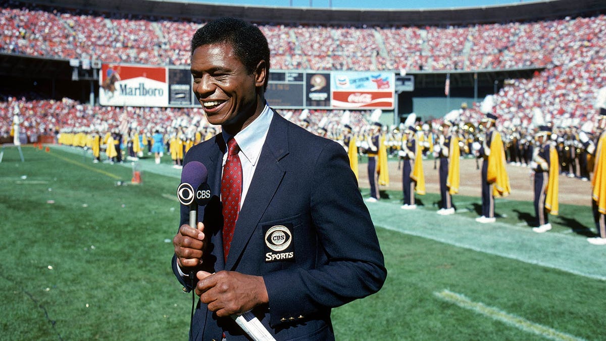 CBS Analyst Irv Cross talks during a game in 1985