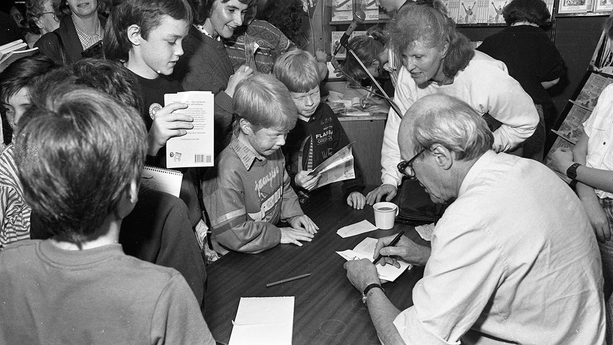 author signing books with children