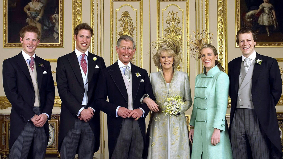 King Charles and Camilla, Queen Consort smiing on their wedding day alongside their children