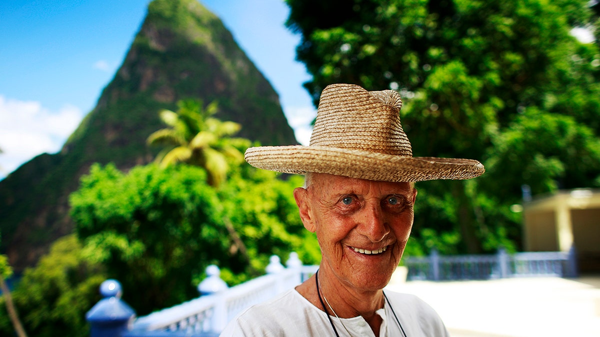 Colin Tennant smiling wearing a hat in Mustique