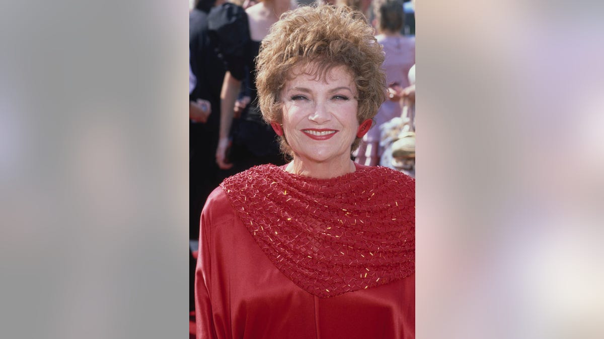 Estelle Getty at the Emmys wearing a red dress