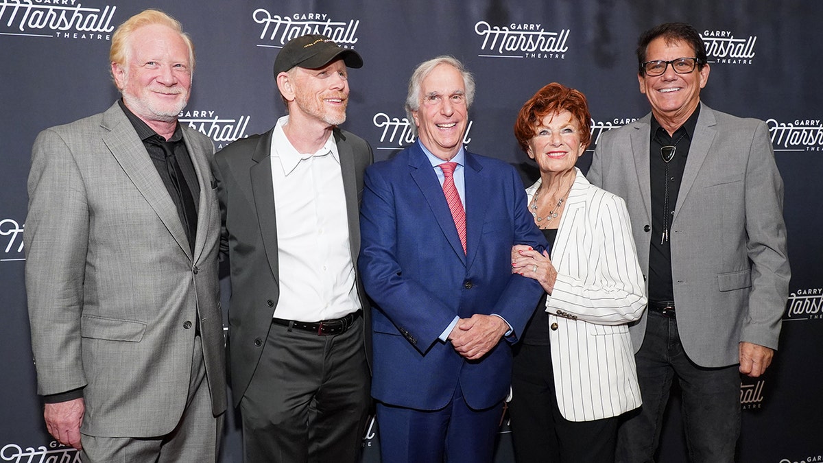 Don Most, Ron Howard, Henry Winkler, Marion Ross and Anson Williams smiling and posing for a photo at a gala