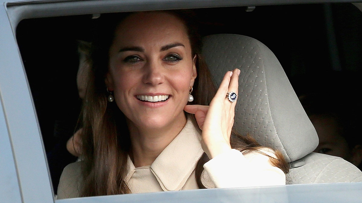 Kate Middleton arriving in style wearing a creame suit