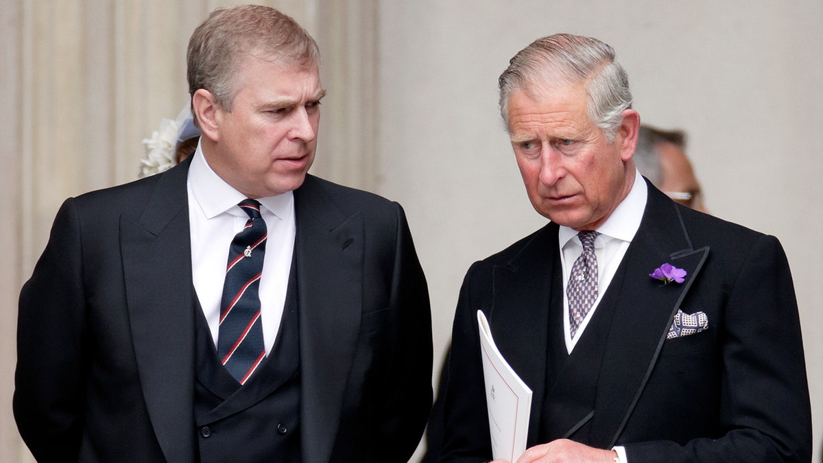 Prince Andrew having a serious conversation with his older brother King Charles III who is listening