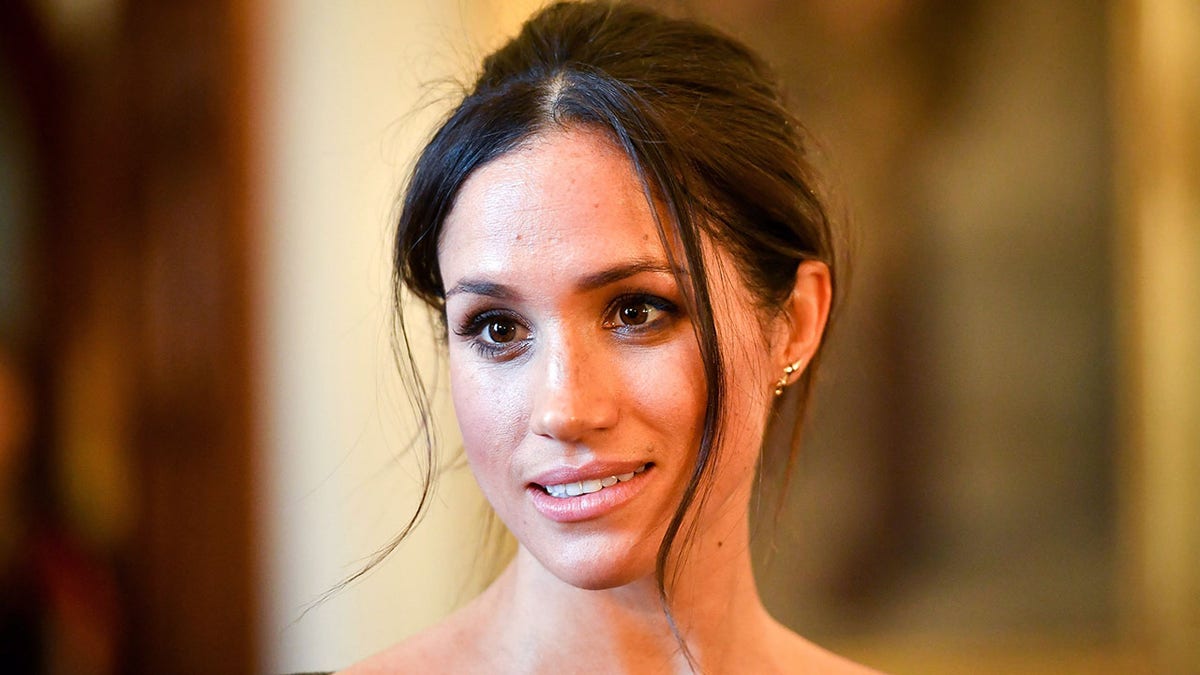 Meghan Markle chats with people inside the Drawing Room during a visit to Cardiff Castle