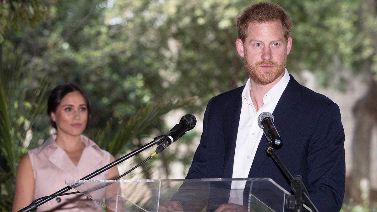 Prince Harry and Meghan Markle making a speech during their royal tour of Africa