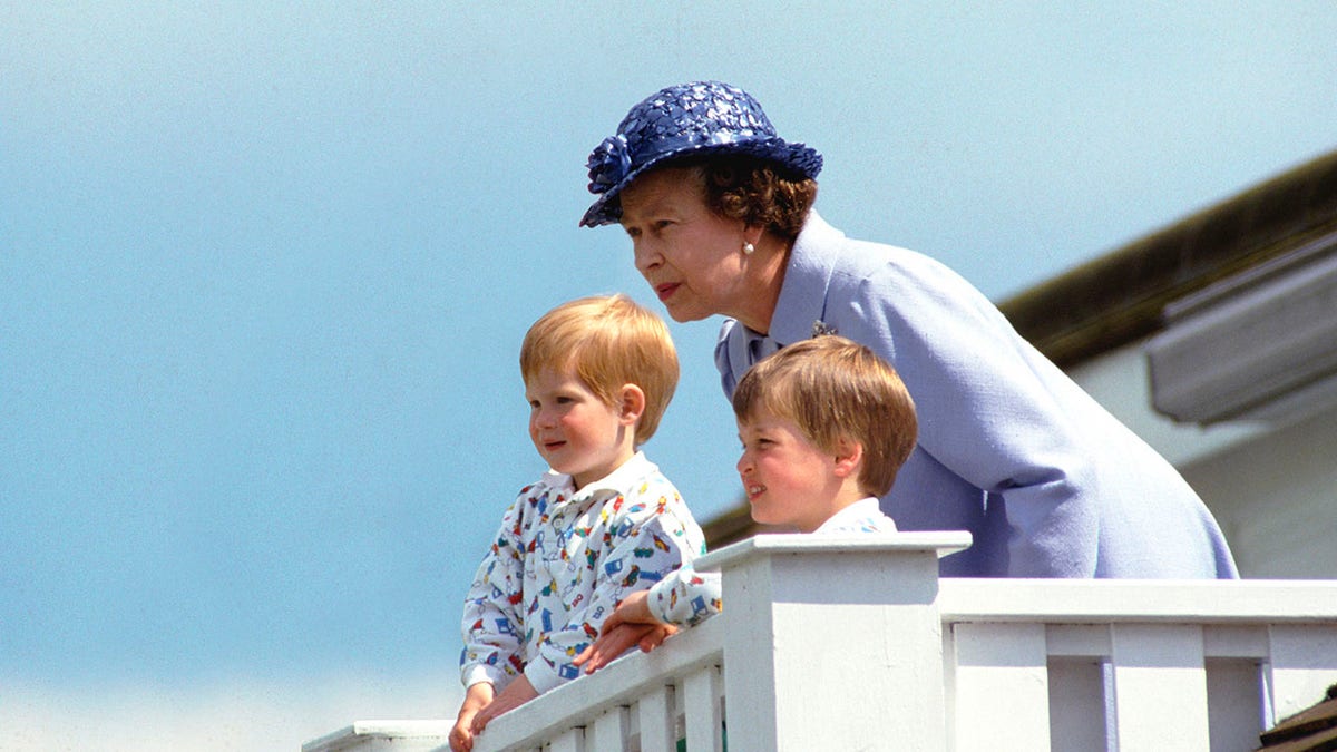 Queen Elizabeth II spending time with a young Prince William and Prince Harry