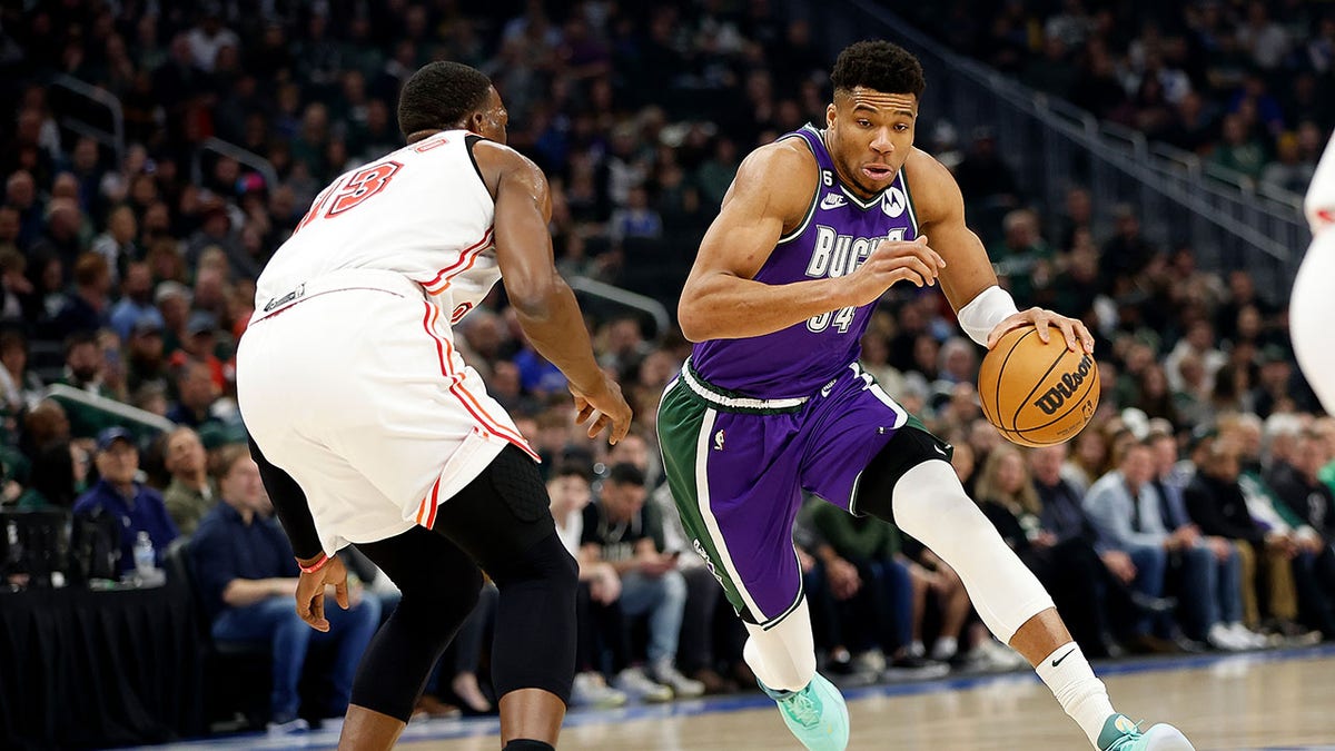 Giannis Antetokounmpo dribbles during a game