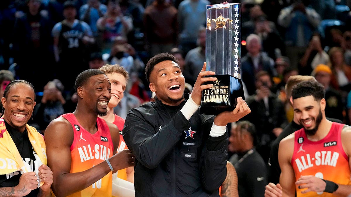 Giannis Antetokounmpo holds the trophy