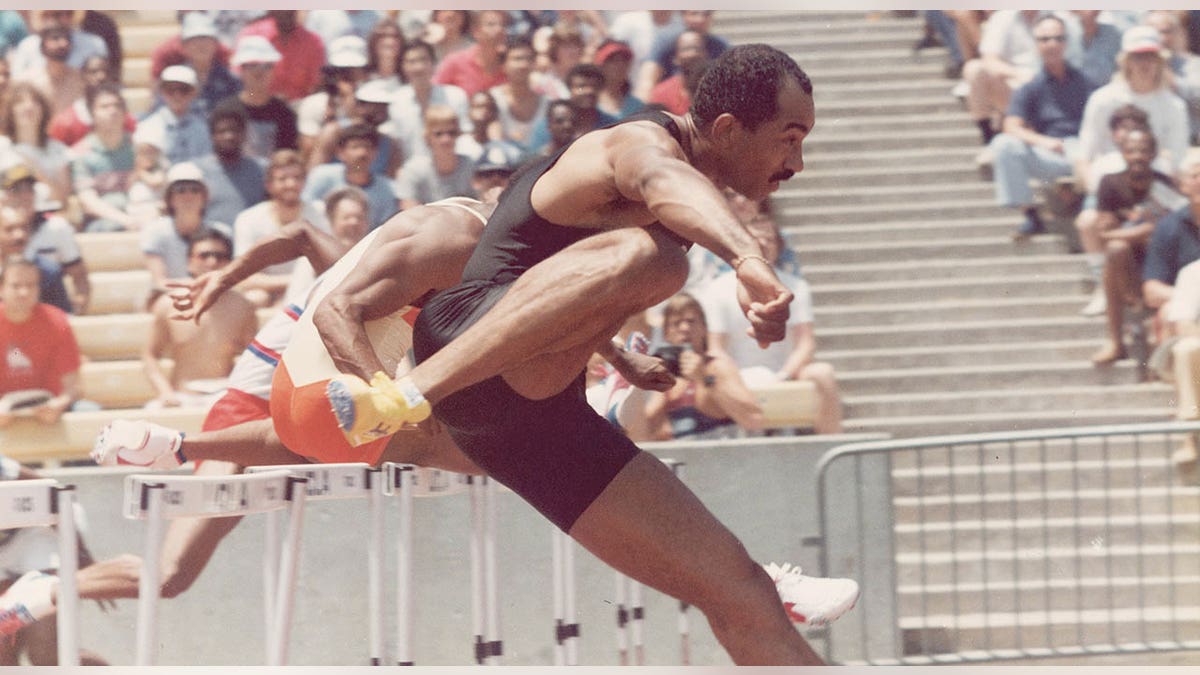 Greg Foster jumps hurdle