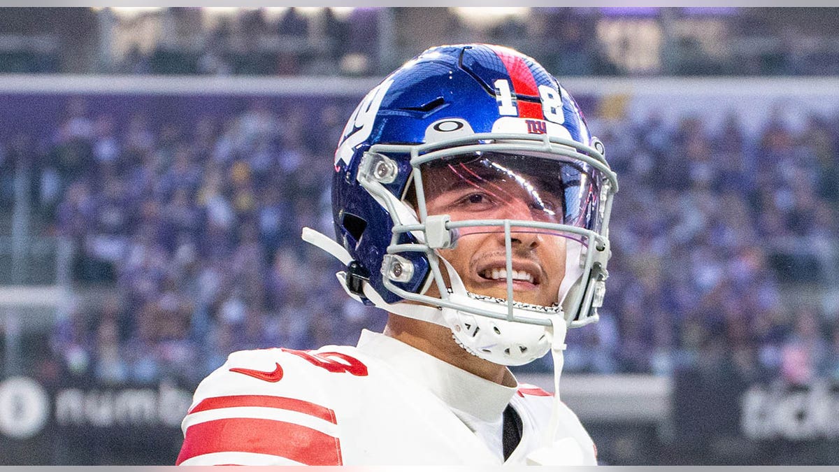 Isaiah Hodgins smiles on field