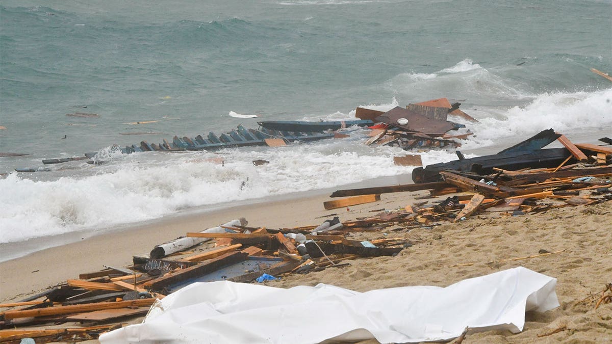 Wreckage and a body washed up on shore.