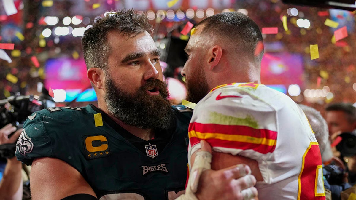 Jason Kelce of the Philadelphia Eagles, left, speaks with his brother Travis Kelce of the Kansas City Chiefs after Super Bowl LVII at State Farm Stadium in Glendale, Arizona, on Feb. 12, 2023.