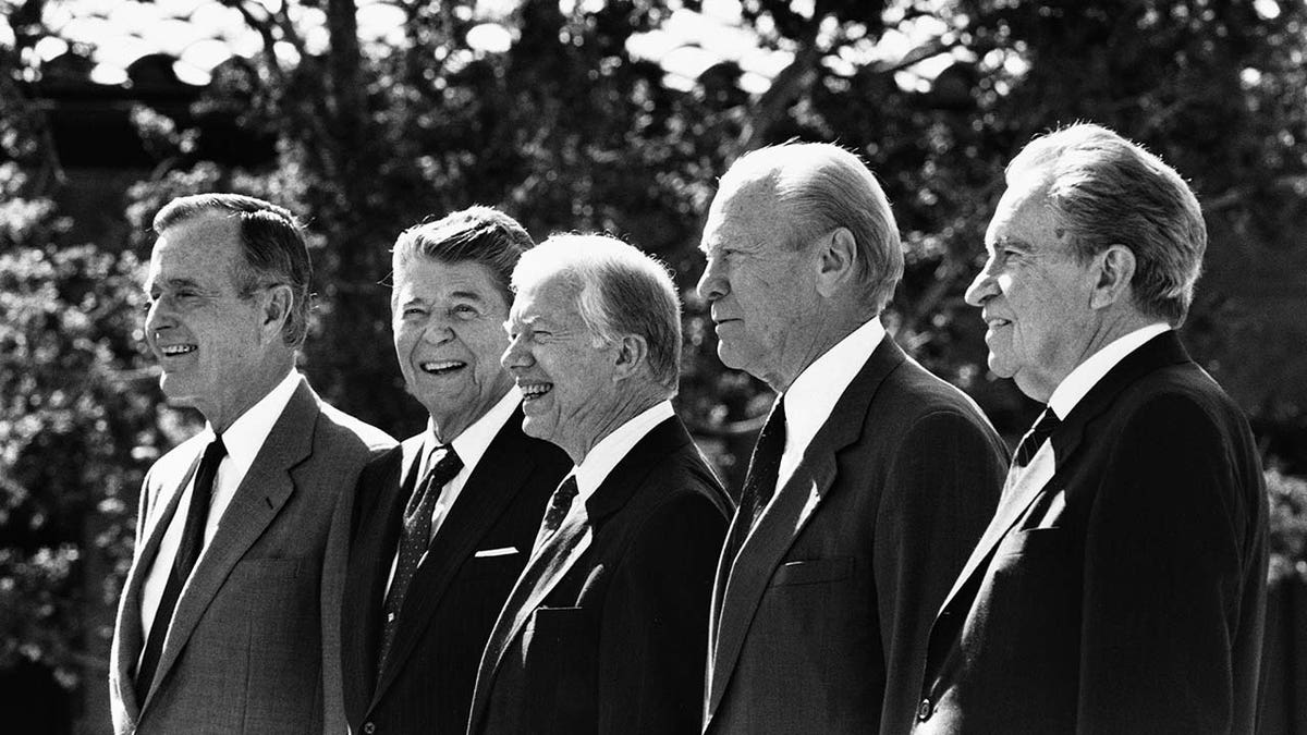Five U.S. Presidents stand next to each other.