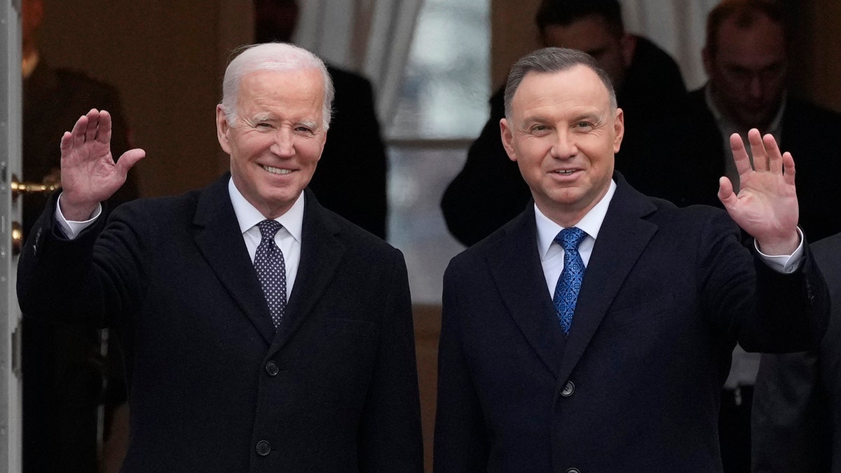 President Biden waves alongside Polish President Andrzej Duda in Warsaw