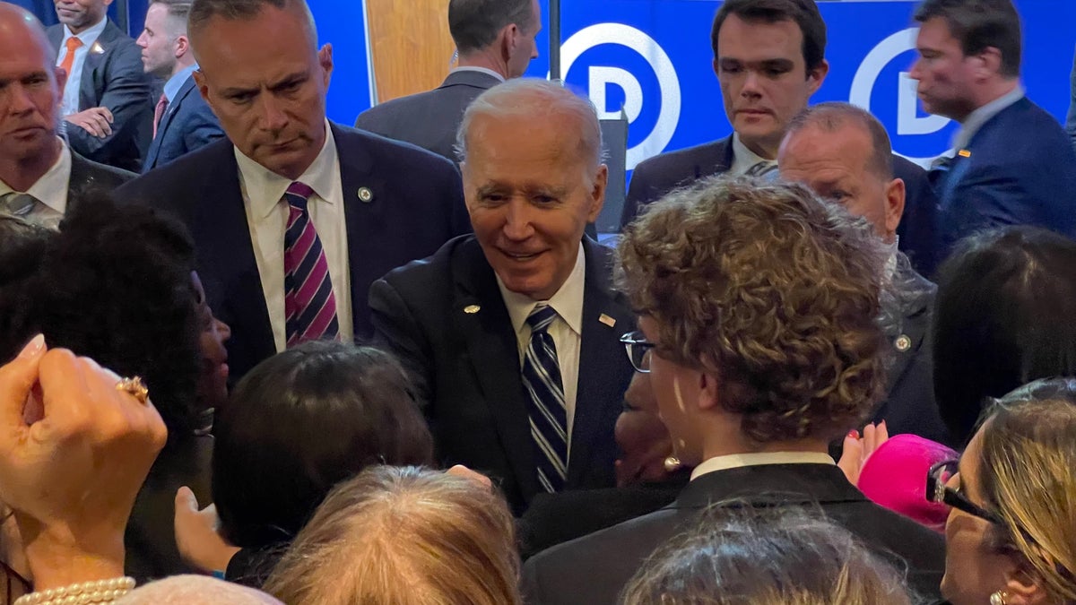 President Biden shakes hands at DNC meeting