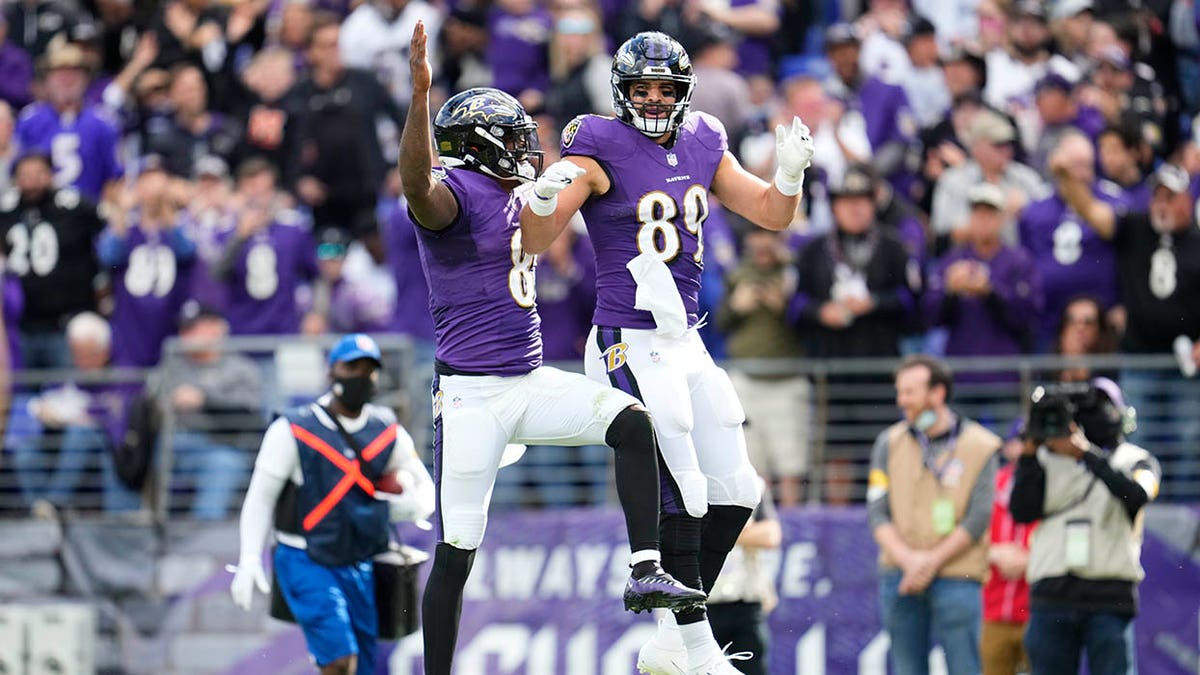 Lamar Jackson and Mark Andrews leap in air