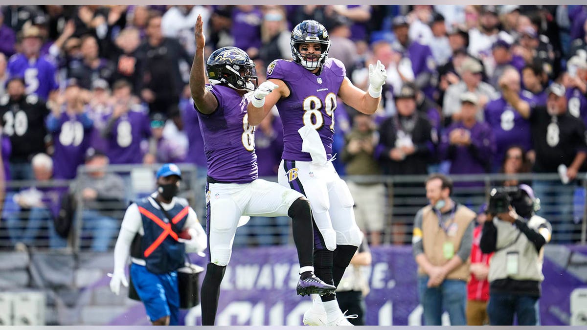 Lamar Jackson and Mark Andrews leap in air