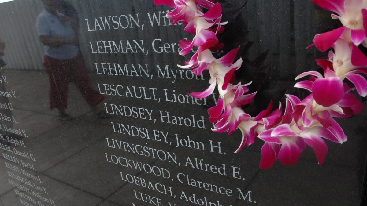 A lei on a memorial for the USS Oklahoma