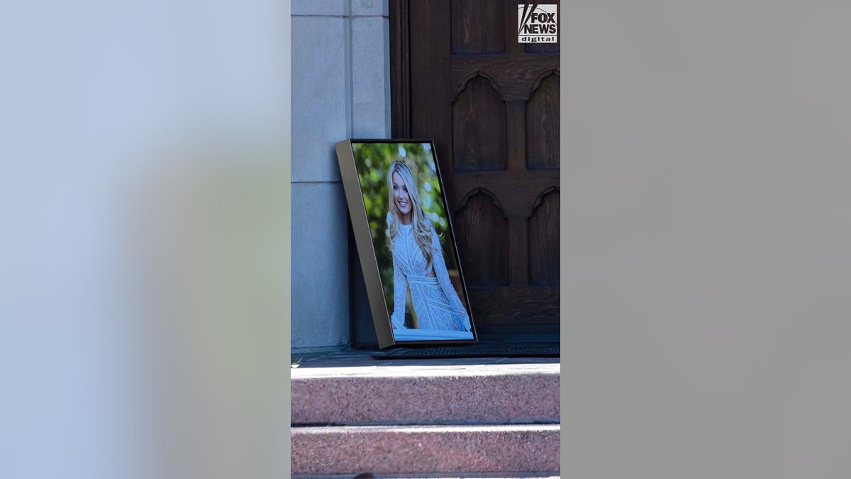 A large photo in a frame sits at a church door