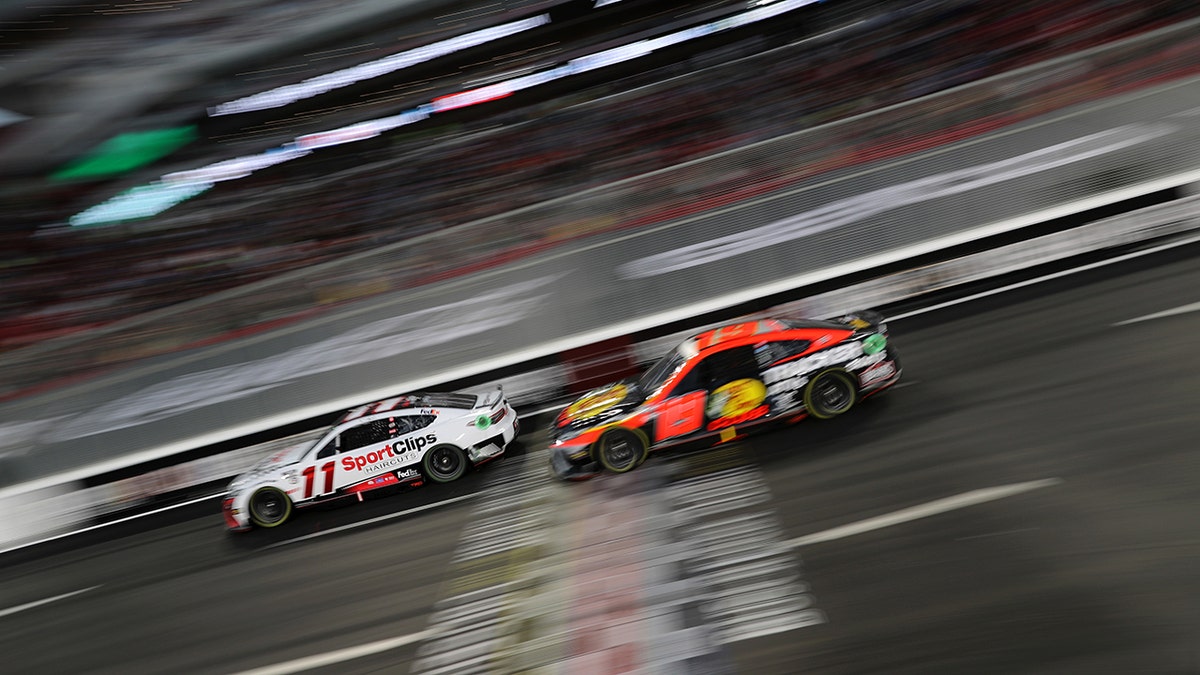 Martin Truex races Denny Hamlin