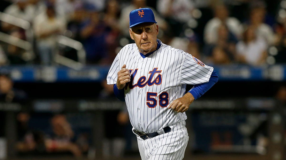 Pitching coach Phil Regan runs towards the dugout